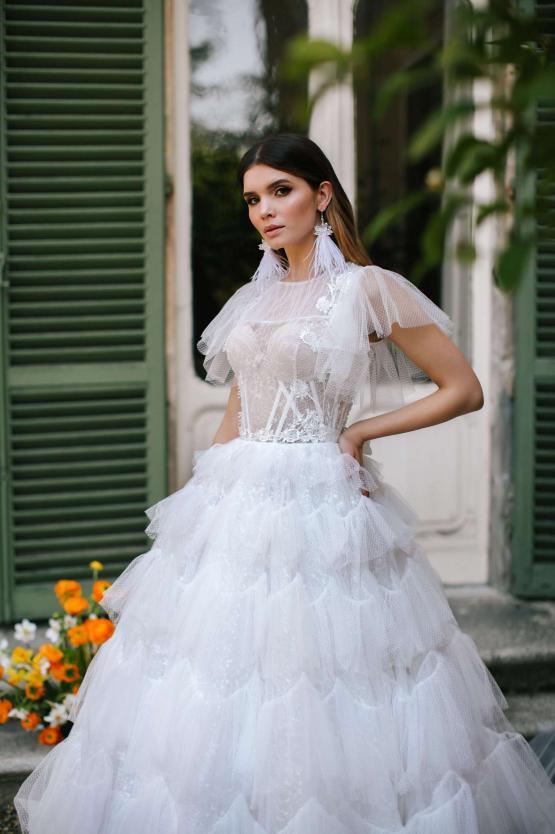 Elegant white tiered tulle bridal gown with ruffled sleeves and embellished waist detail — Blammo Biamo | Endless UAE