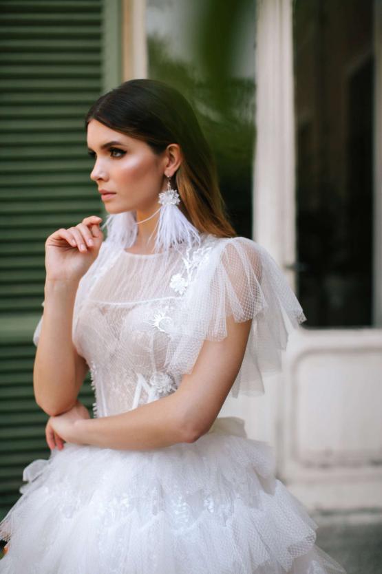 Elegant white tiered tulle bridal gown with ruffled sleeves and embellished waist detail — Blammo Biamo | Endless UAE