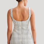 Woman wearing white tweed mini dress with grid pattern and scoop neckline — Meshki | Endless UAE