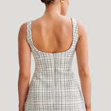 Woman wearing white tweed mini dress with grid pattern and scoop neckline — Meshki | Endless UAE