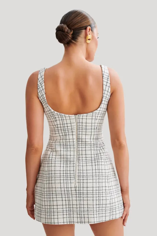 Woman wearing white tweed mini dress with grid pattern and scoop neckline — Meshki | Endless UAE
