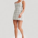 Woman wearing white tweed mini dress with grid pattern and scoop neckline — Meshki | Endless UAE