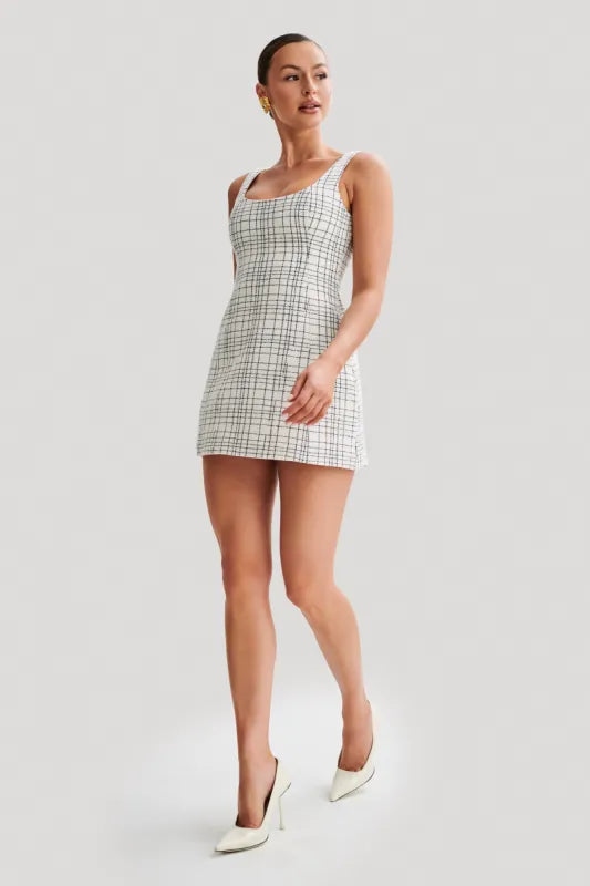 Woman wearing white tweed mini dress with grid pattern and scoop neckline — Meshki | Endless UAE