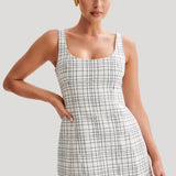 Woman wearing white tweed mini dress with grid pattern and scoop neckline — Meshki | Endless UAE