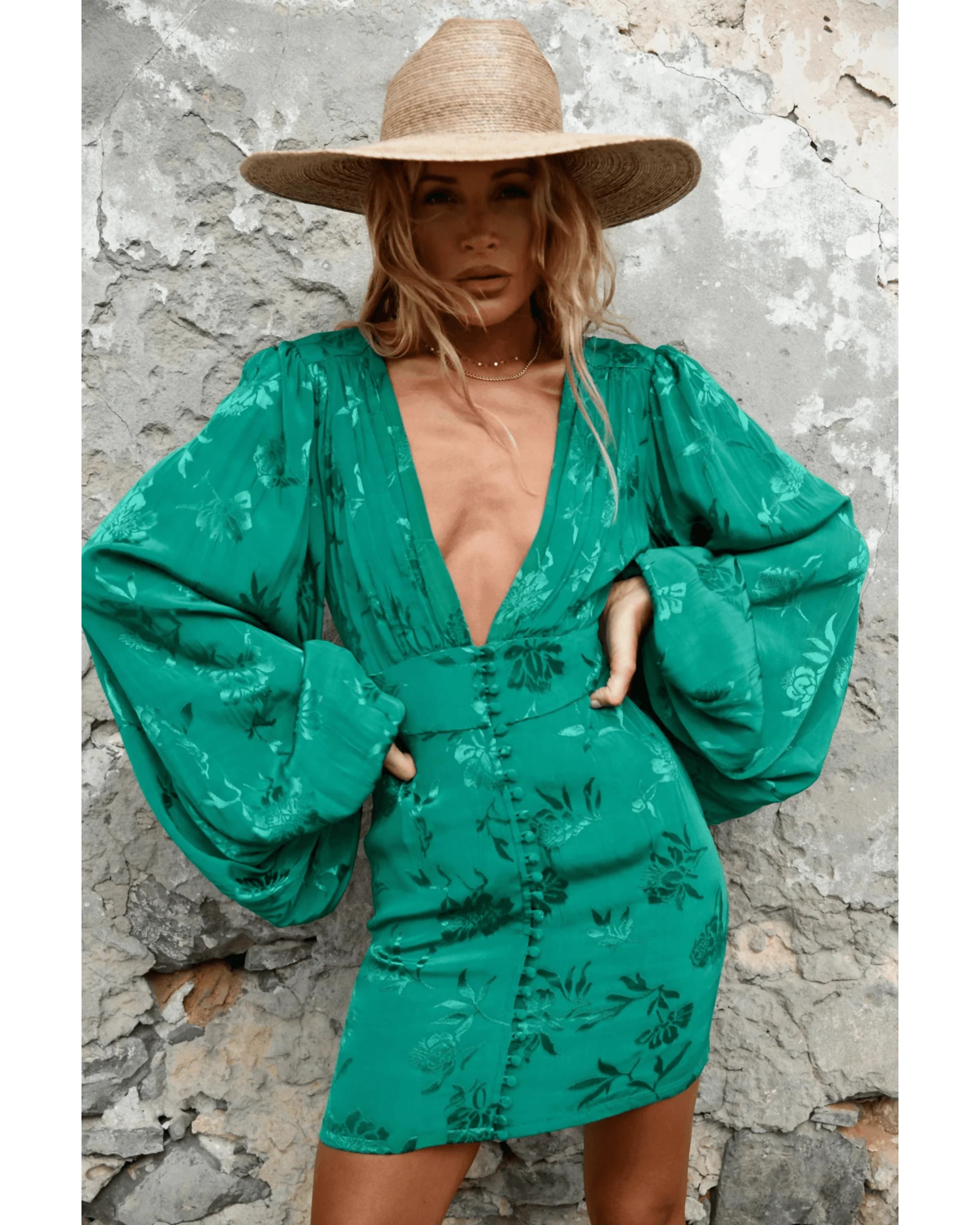 Green floral jacquard mini dress with deep V-neckline and balloon sleeves styled with straw hat — Rat & Boa | Endless UAE