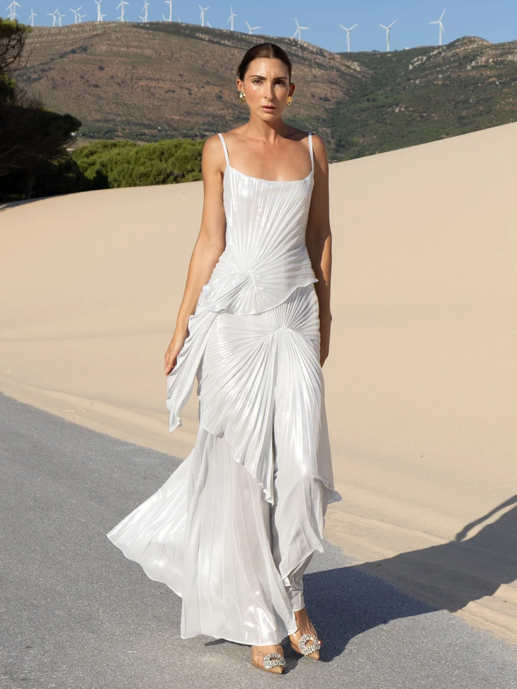 Woman wearing white draped Torrent Dress in modern architectural setting — Georgia Hardinge | Endless UAE
