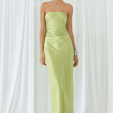 Woman wearing lime green strapless maxi dress against white curtain backdrop — Endless | Endless UAE