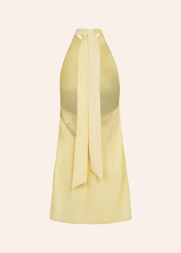 Woman wearing yellow halter neck dress on beach with sunglasses and accessories — Dvete | Endless UAE