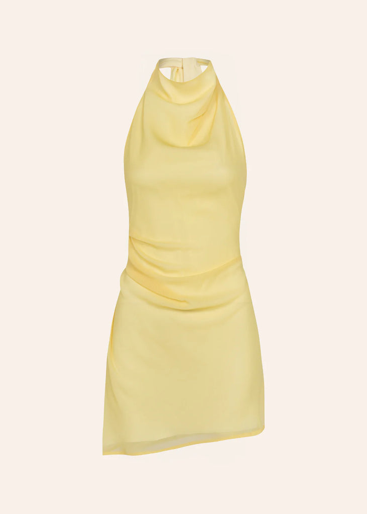 Woman wearing yellow halter neck dress on beach with sunglasses and accessories — Dvete | Endless UAE