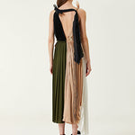 Woman wearing pleated asymmetric maxi dress in black, blush pink and red with black ankle strap heels — Victoria Beckham | Endless UAE
