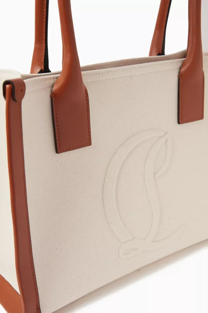 Ivory canvas tote bag with tan leather trim and handles featuring embossed logo detail — Christian Louboutin | Endless UAE