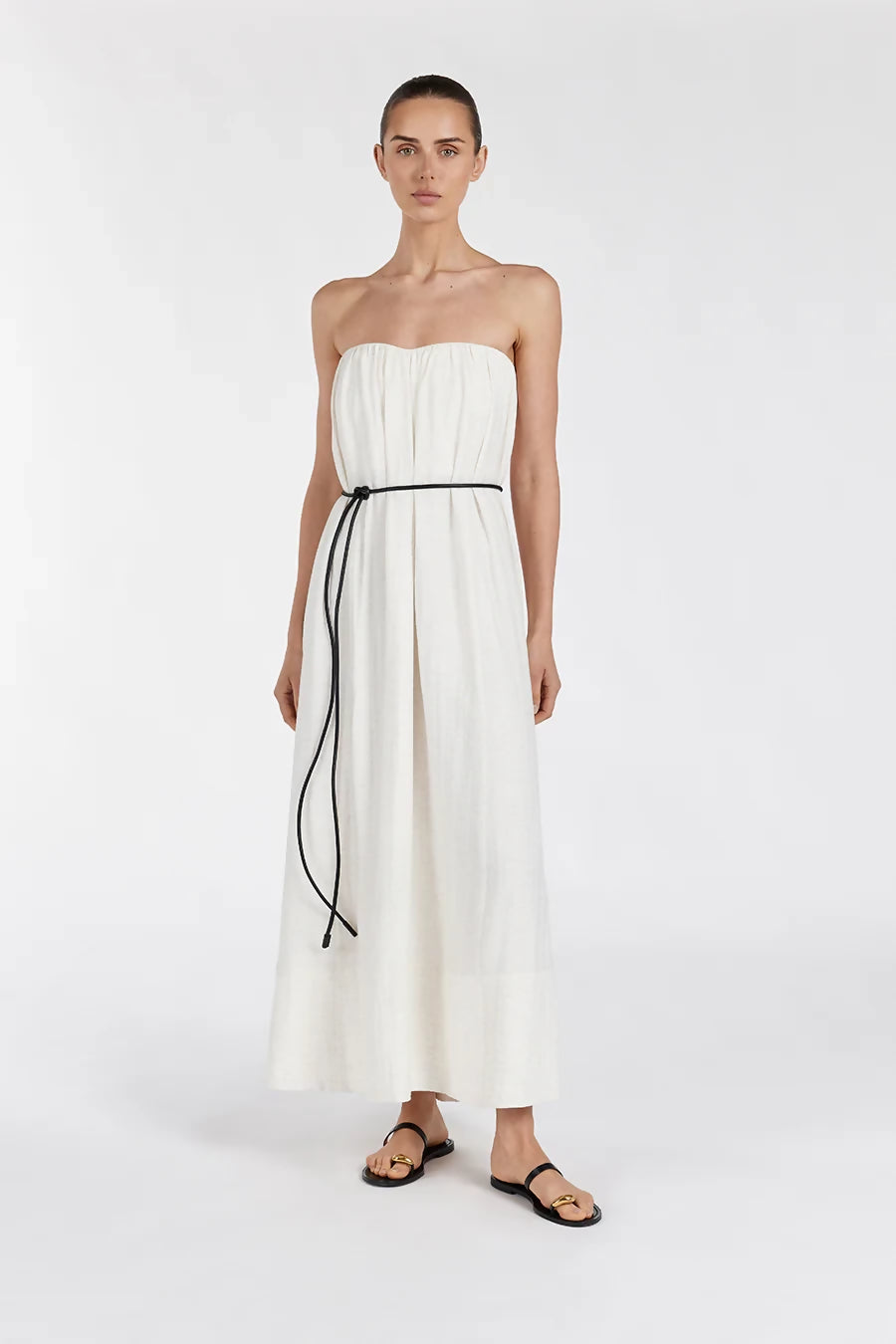 Model wearing Shaniya Cream Marle strapless midi dress with black tie belt and sandals — Dissh | Endless UAE
