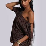 Model wearing brown zebra print backless mini dress with one shoulder sleeve and gold cuff bracelet — Jaded London | Endless UAE