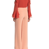 Peach wide-leg pants with high waist and flowing silhouette, styled with coral ruffled blouse — Diane Von Furstenberg | Endless UAE