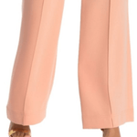 Wide leg trousers in soft peach featuring pressed center creases, relaxed silhouette, and paired with gold sandals — Diane Von Furstenberg | Endless UAE