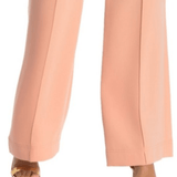 Wide leg trousers in soft peach featuring pressed center creases, relaxed silhouette, and paired with gold sandals — Diane Von Furstenberg | Endless UAE