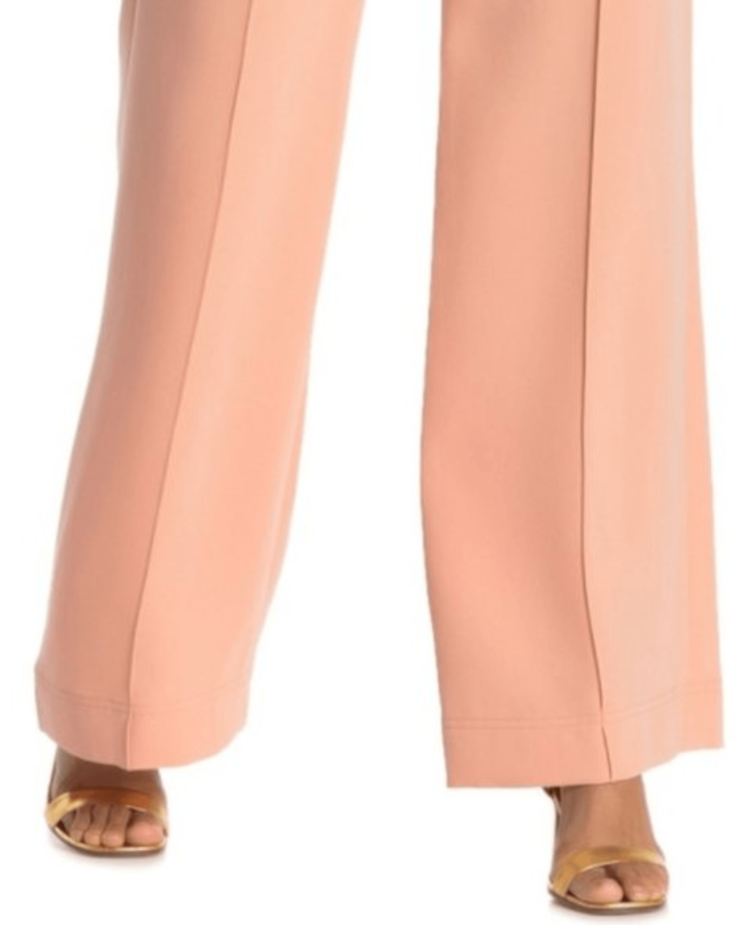 Wide leg trousers in soft peach featuring pressed center creases, relaxed silhouette, and paired with gold sandals — Diane Von Furstenberg | Endless UAE