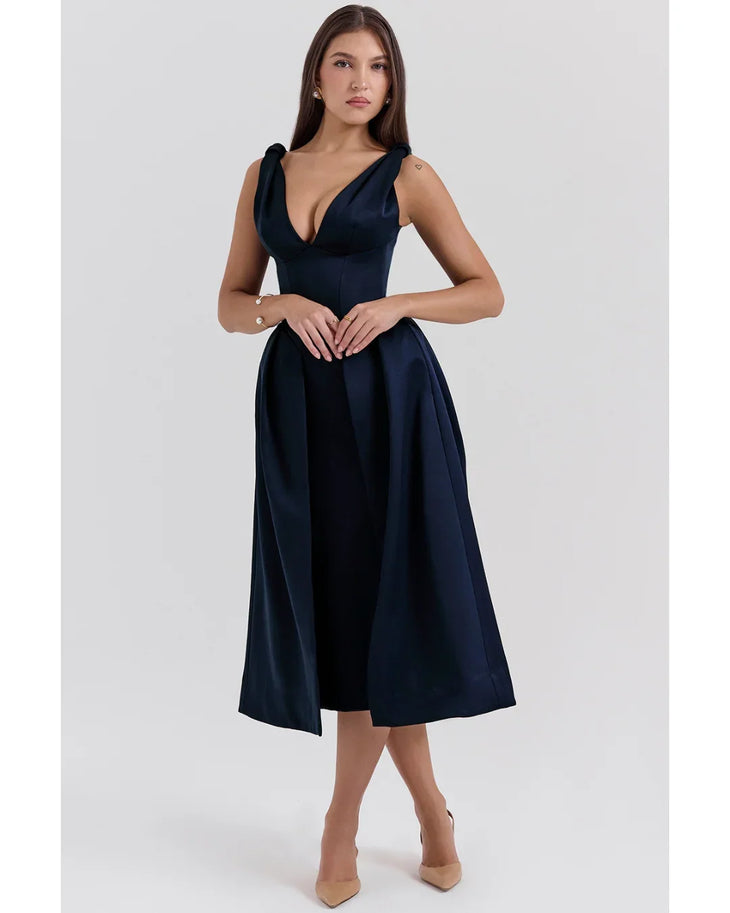 Woman wearing navy blue satin midi dress with twisted shoulder straps and full skirt — House of CB | Endless UAE