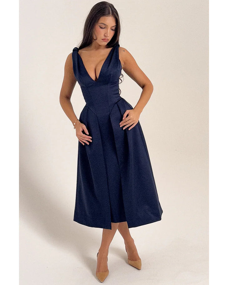 Woman wearing navy blue satin midi dress with twisted shoulder straps and full skirt — House of CB | Endless UAE