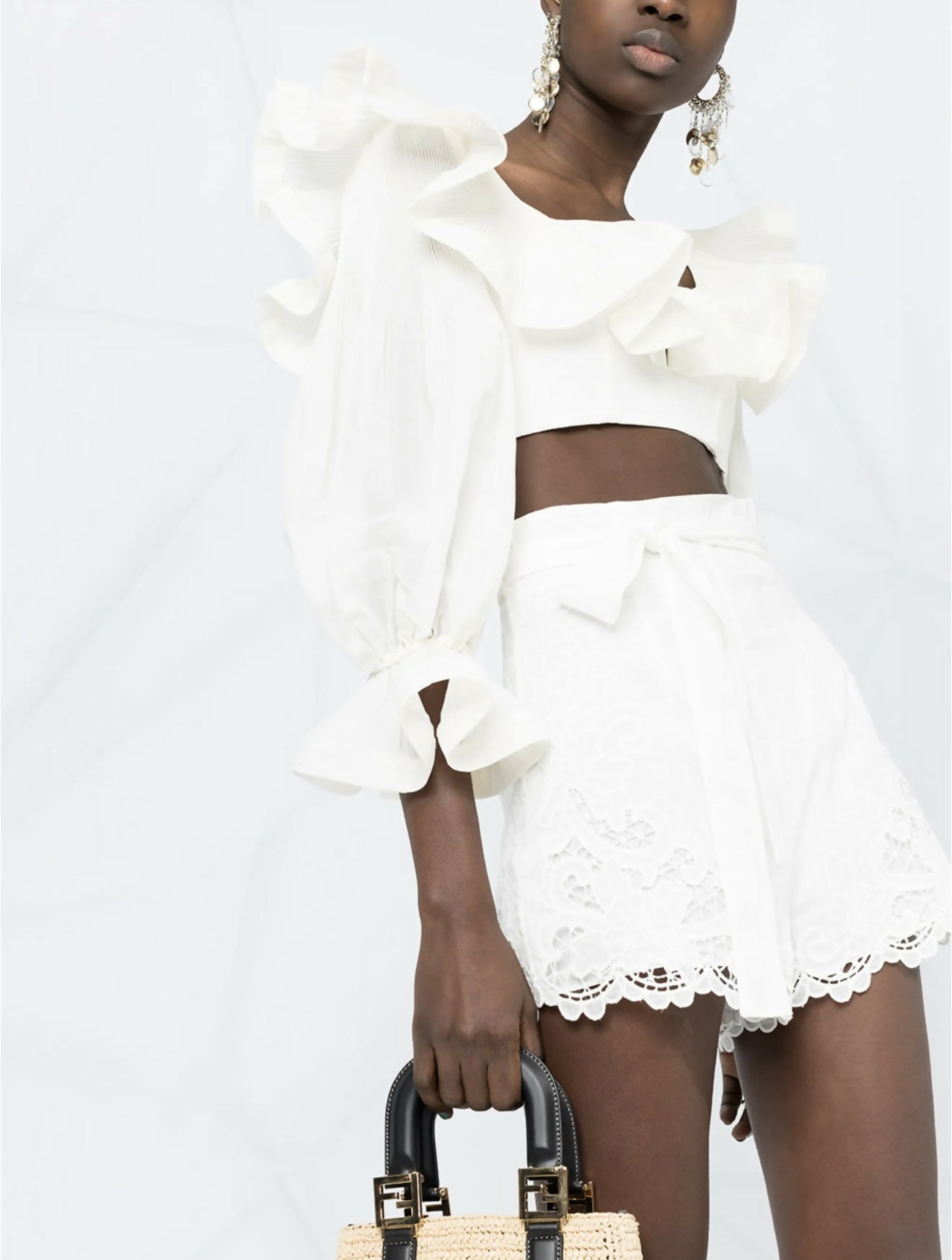White embroidered shorts with scalloped hem and belted waist detail on model — Zimmermann | Endless UAE
