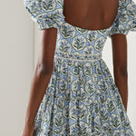 Woman wearing blue floral cotton mini dress with puff sleeves and cream tote bag — Agua by Agua Bendita | Endless UAE