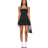 Black halter neck mini dress with bubble hem detail, worn with white socks and black pointed shoes — Lioness | Endless UAE