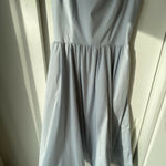 Woman wearing light blue sleeveless midi dress with corset top and full skirt — Endless | Endless UAE
