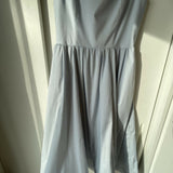 Woman wearing light blue sleeveless midi dress with corset top and full skirt — Endless | Endless UAE