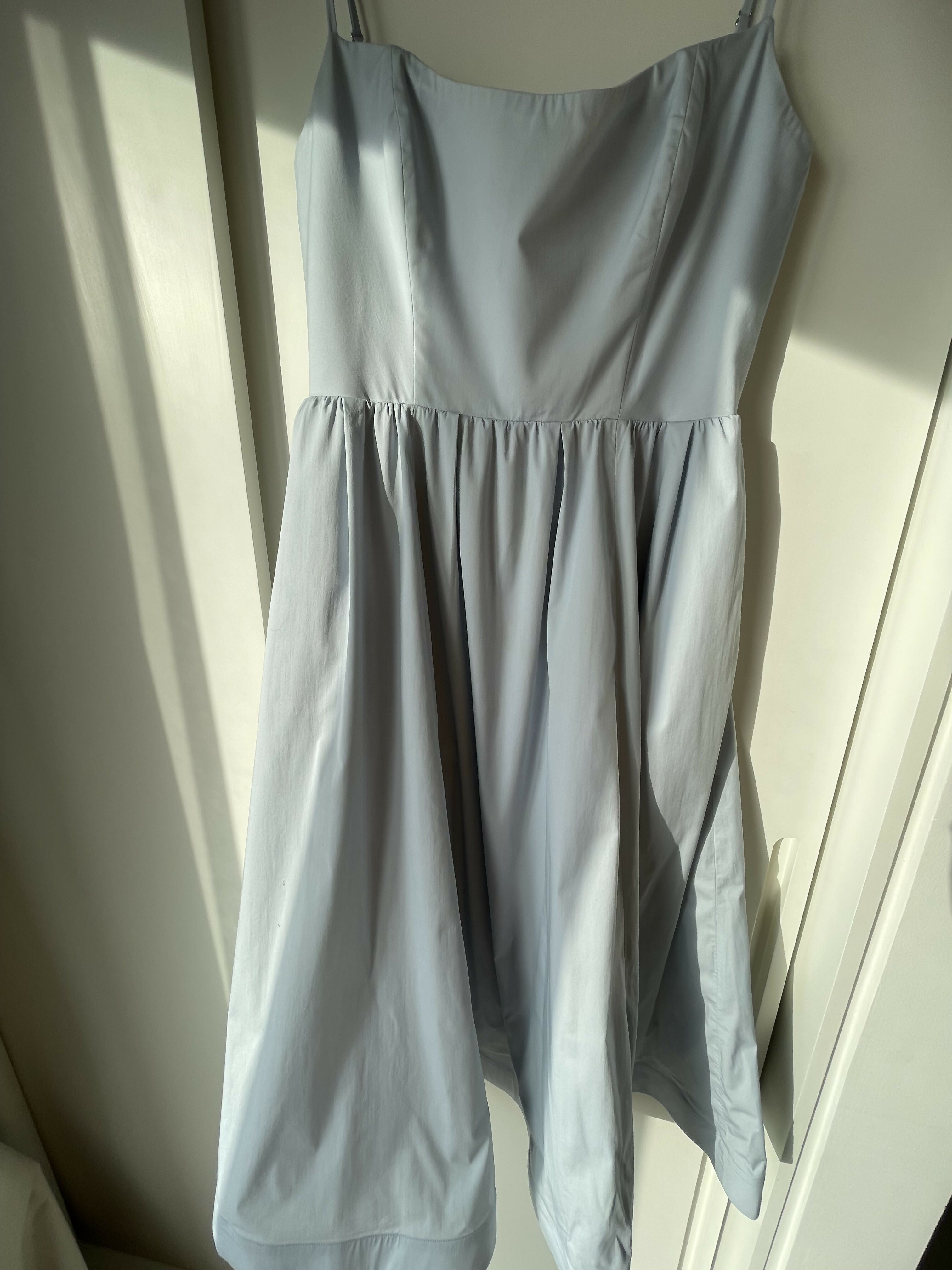 Woman wearing light blue sleeveless midi dress with corset top and full skirt — Endless | Endless UAE