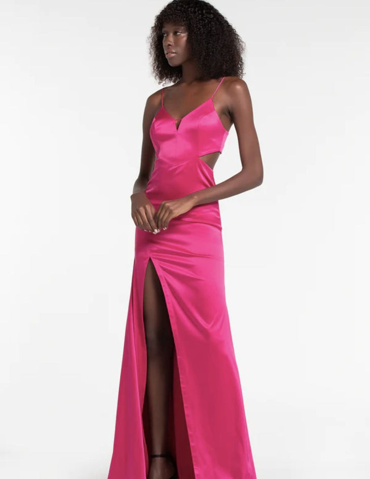 Long pink satin party dress with spaghetti straps, side cutouts, and high slit worn by model — Lily Blanc | Endless UAE