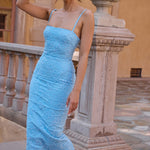 Blue floral embroidered maxi dress with thin straps on model sitting on chair — House of CB | Endless UAE