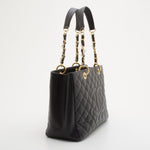 Black quilted caviar leather tote with gold chain and leather straps on white background — Chanel | Endless UAE