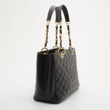 Black quilted caviar leather tote with gold chain and leather straps on white background — Chanel | Endless UAE