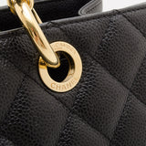 Black quilted caviar leather with gold-tone chain hardware detail close-up view — Chanel | Endless UAE