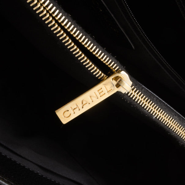 Gold zipper pull with Chanel branding on black caviar leather Grand Shopper Tote — Chanel | Endless UAE