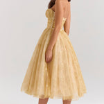 Woman wearing gold metallic lace tulle strapless midi gown with ruched waist — House of CB | Endless UAE