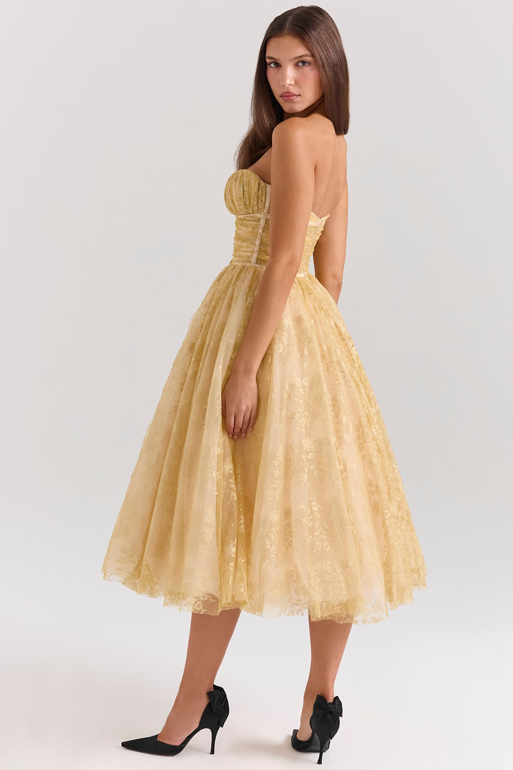 Woman wearing gold metallic lace tulle strapless midi gown with ruched waist — House of CB | Endless UAE