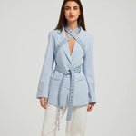 Fylis light blue blazer with studded straps and tie belt on model wearing cream trousers — Mayka | Endless UAE