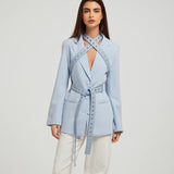 Fylis light blue blazer with studded straps and tie belt on model wearing cream trousers — Mayka | Endless UAE