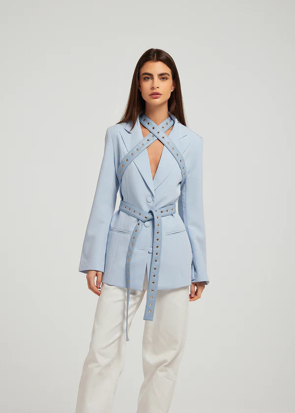 Fylis light blue blazer with studded straps and tie belt on model wearing cream trousers — Mayka | Endless UAE