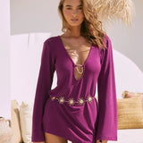 Purple mini dress with plunging neckline, long sleeves, and gold sun chain belt detail — Beach City | Endless UAE