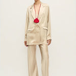 Woman wearing a relaxed hazelnut blazer and matching trousers with a red pendant necklace — Silk Laundry | Endless UAE