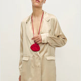 Woman wearing a relaxed hazelnut blazer and matching trousers with a red pendant necklace — Silk Laundry | Endless UAE