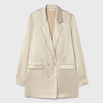 Woman wearing a relaxed hazelnut blazer and matching trousers with a red pendant necklace — Silk Laundry | Endless UAE