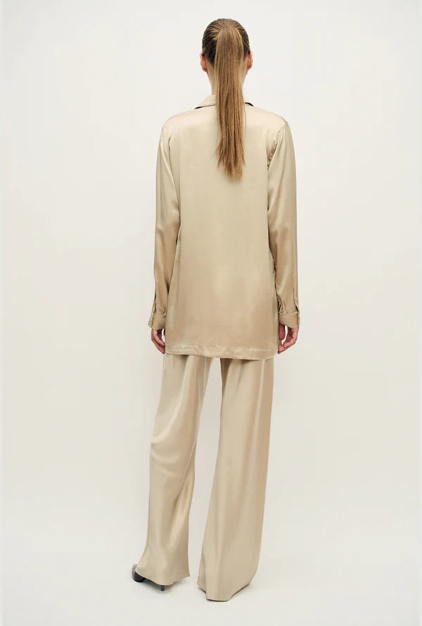 Woman wearing a relaxed hazelnut blazer and matching trousers with a red pendant necklace — Silk Laundry | Endless UAE