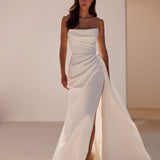 Elegant white strapless wedding gown with asymmetrical draping, high slit, and flowing train — Milla Nova | Endless UAE
