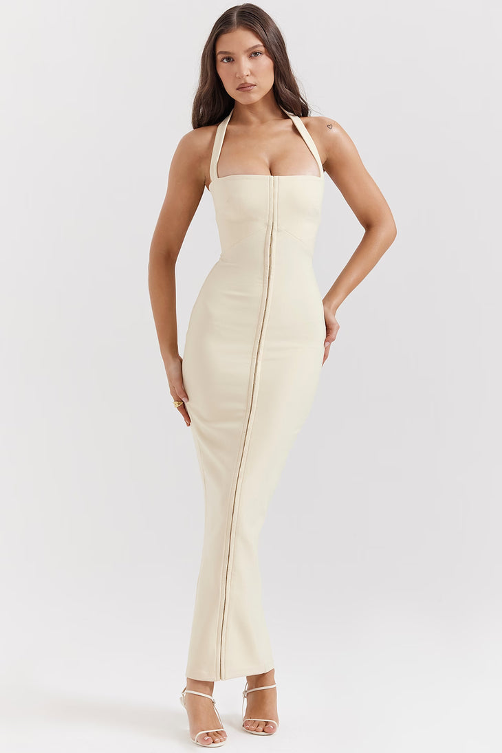 Woman wearing cream halter maxi dress with front zip detail and strappy white sandals — House of CB | Endless UAE