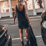 Black sequin sleeveless mini dress with scoop back, styled with ankle boots and blazer — Mikuta | Endless UAE
