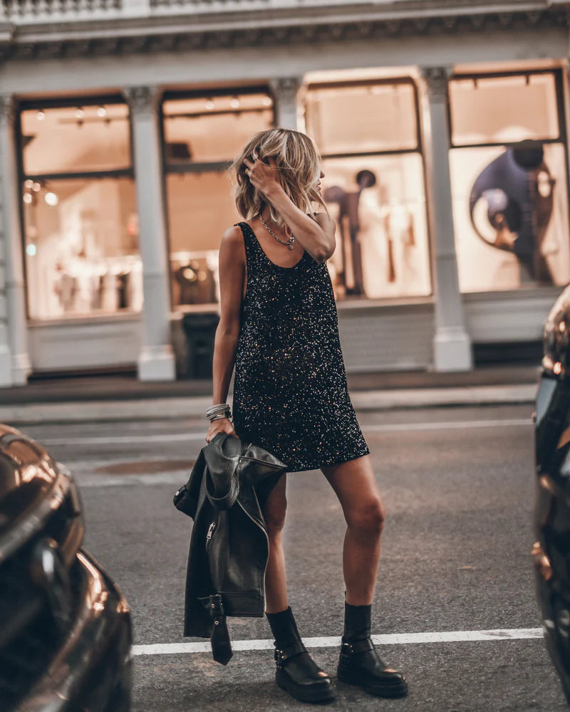 Black sequin sleeveless mini dress with scoop back, styled with combat boots and leather jacket — Mikuta | Endless UAE