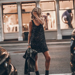 Black sequin sleeveless mini dress with scoop back, styled with combat boots and leather jacket — Mikuta | Endless UAE